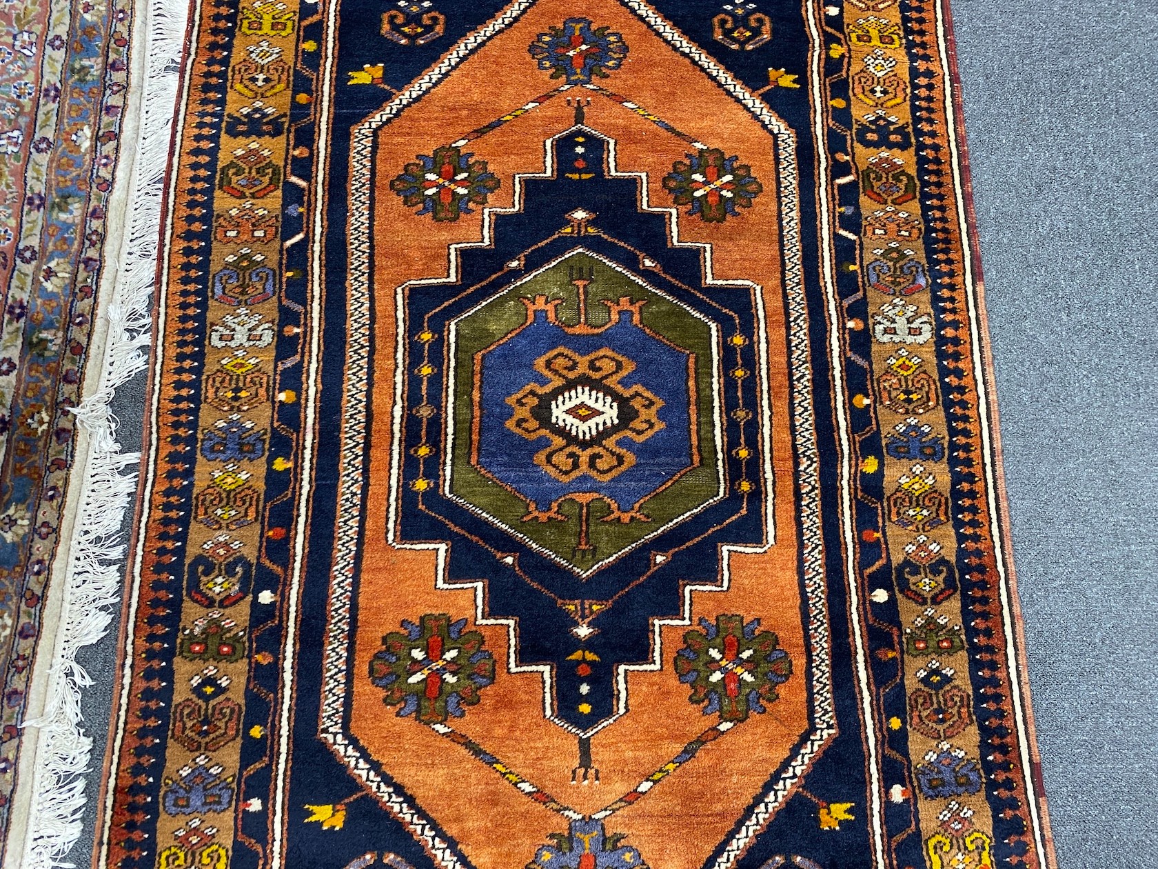 A Caucasian design blue ground rug, 204 x 104cm